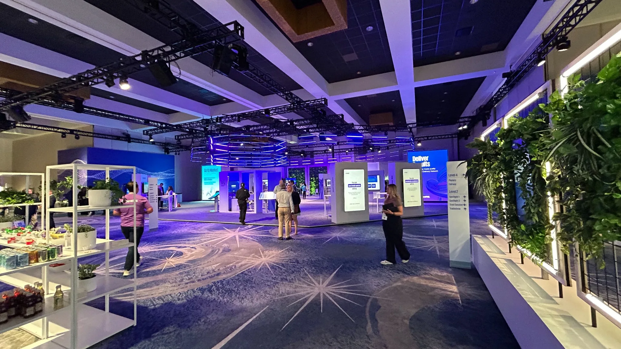 Large corporate experience floor with digital signage, exhibit structures and overhead production rigging